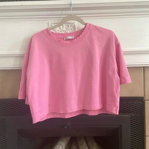 This is the brand Zara. The color is a pink. This is a cropped tee.
